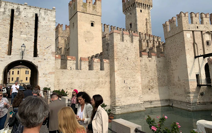 Sirmione Castle with tourists exploring the historic site in Verona, Italy.
