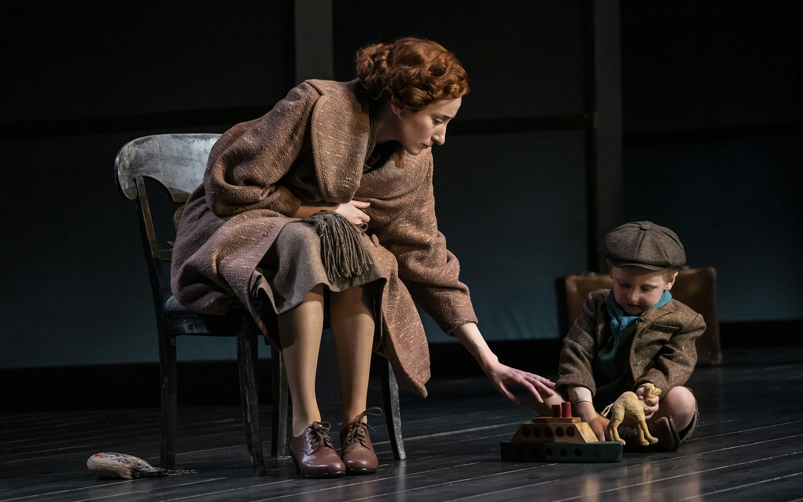 Woman and child playing with toy ship on stage in Leopoldstadt performance.