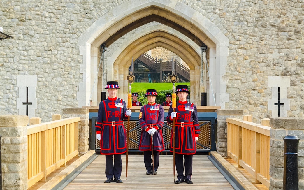 Beefeaters standing at the entrance of the Tower of London.