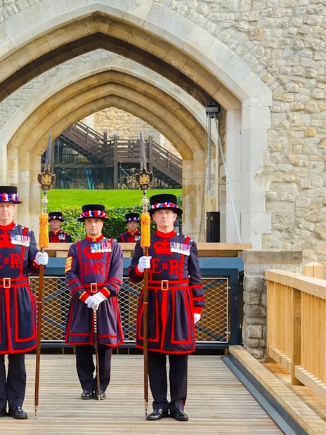 Beefeaters standing at the entrance of the Tower of London.