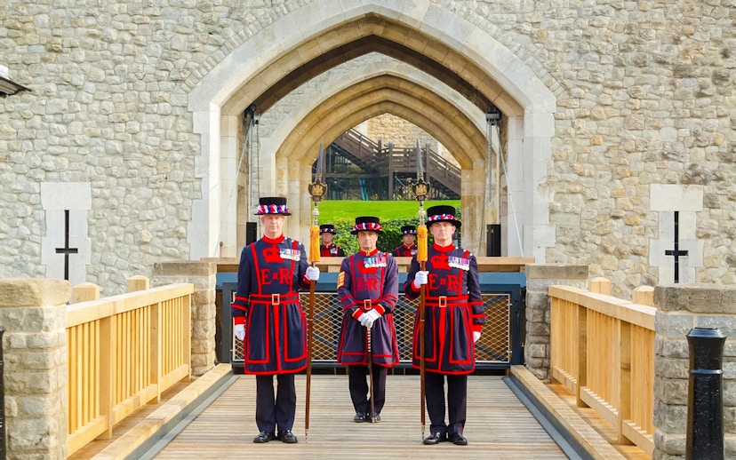 Beefeaters standing at the entrance of the Tower of London.