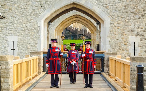 Beefeaters standing at the entrance of the Tower of London.