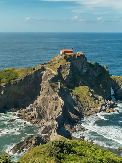Stone path leading to San Juan de Gaztelugatxe chapel on rocky islet, Basque Country, Spain.