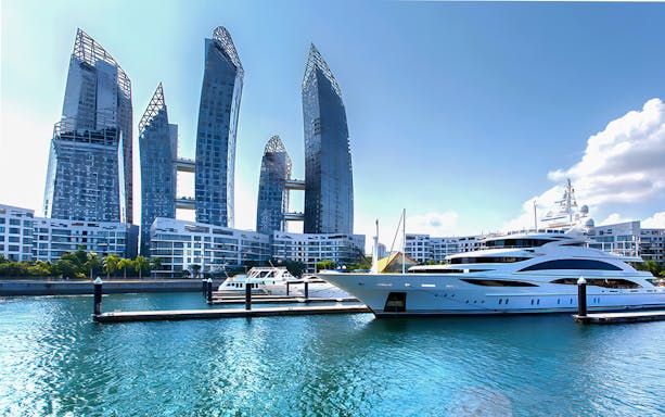 Singapore skyline view from yacht with modern skyscrapers and marina.