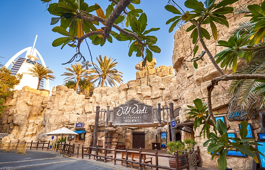 Family enjoying a thrilling water slide at Wild Wadi Water Park in Dubai, a popular tour destination for Tickets to Wild Wadi Water Park