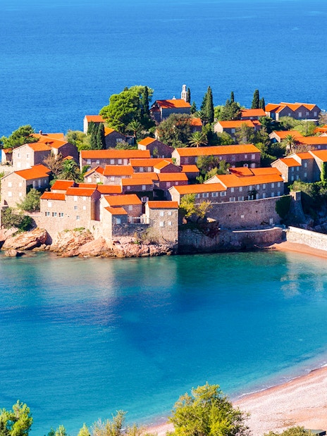 St. Stefan island with historic buildings and beach, Montenegro.