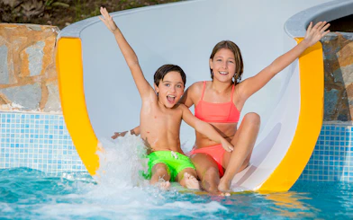 Children enjoying a water slide at Aqualand Costa Adeje.