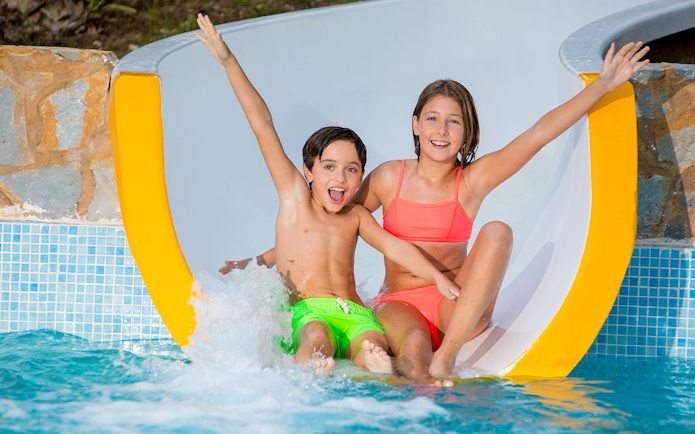 Children enjoying a water slide at Aqualand Costa Adeje.