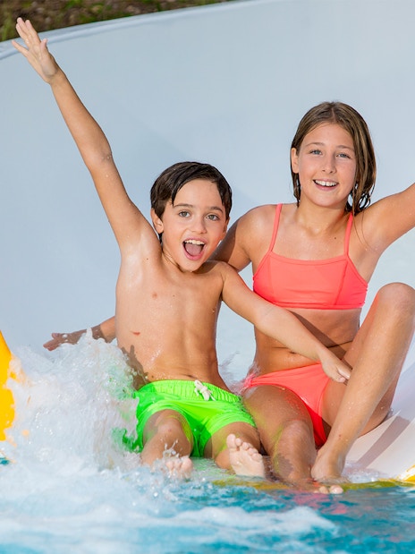 Children enjoying a water slide at Aqualand Costa Adeje.