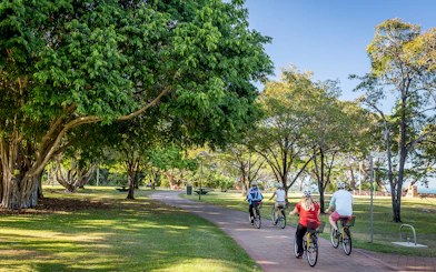 Cyclists on a scenic path during a guided half-day city tour of Darwin.