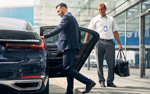 Man entering car for airport pickup during Warsaw layover.