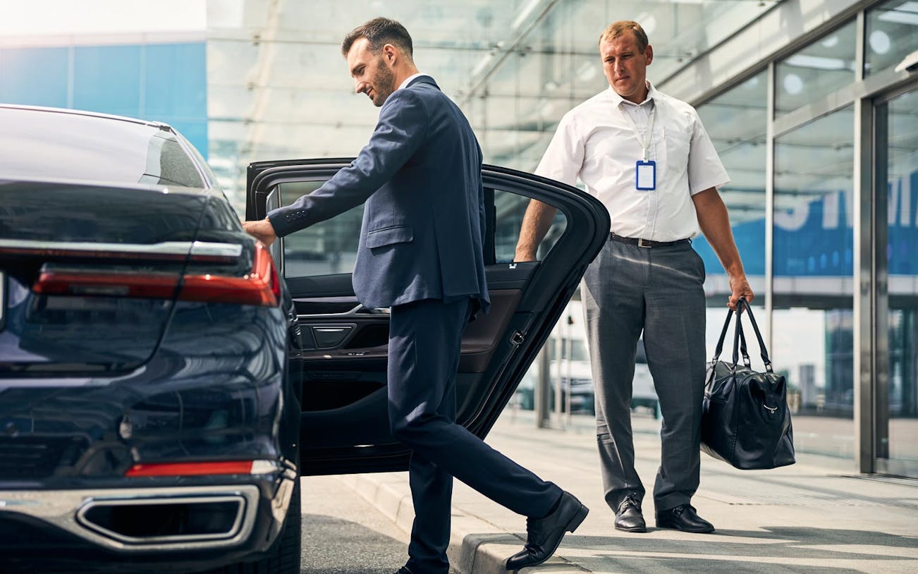 Man entering car for airport pickup during Warsaw layover.