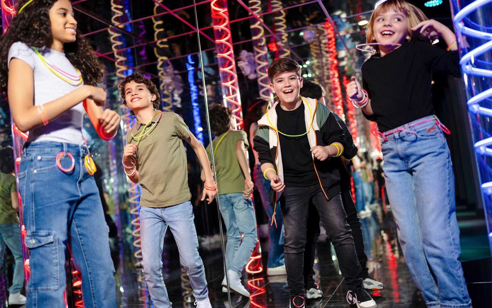 Children enjoying Nickelodeon Universe at American Dream with colorful lights.