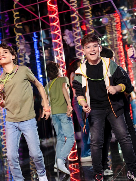 Children enjoying Nickelodeon Universe at American Dream with colorful lights.