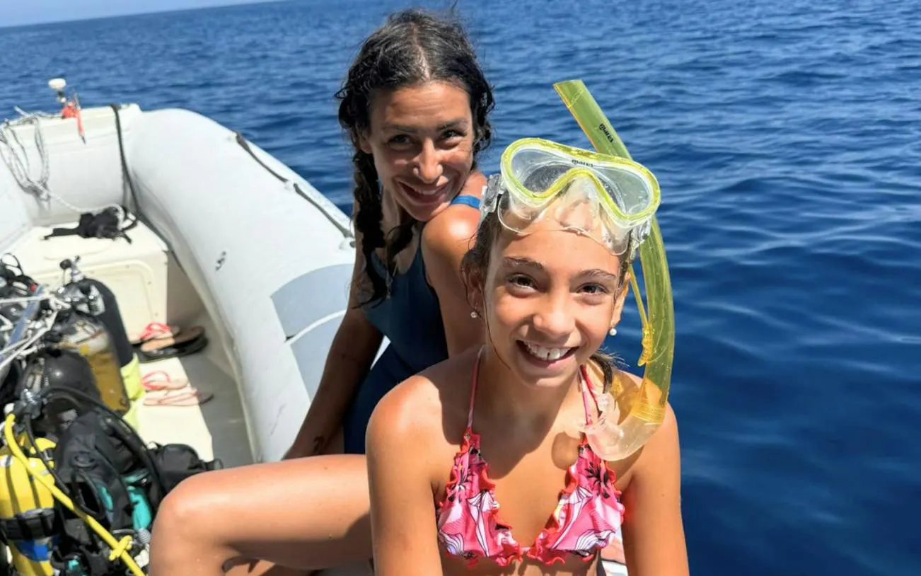 Two people on a RIB boat with snorkeling gear, Olbia tour.