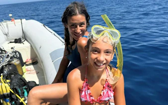 Two people on a RIB boat with snorkeling gear, Olbia tour.
