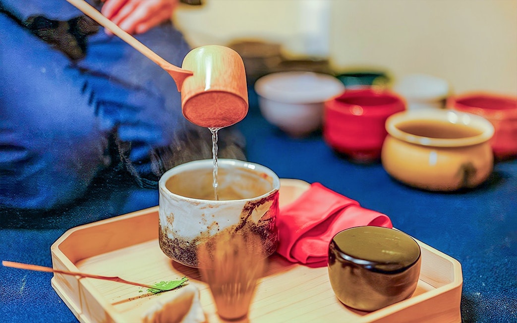 Pouring water into a tea bowl during a private tea ceremony with wagashi in Japan.