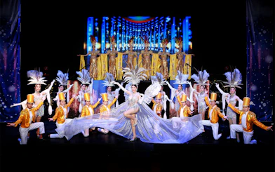 Performers in elaborate costumes on stage at Siam Dragon Cabaret Show, Thailand.