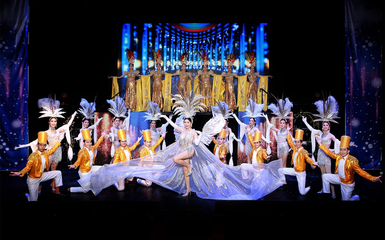 Performers in elaborate costumes on stage at Siam Dragon Cabaret Show, Thailand.