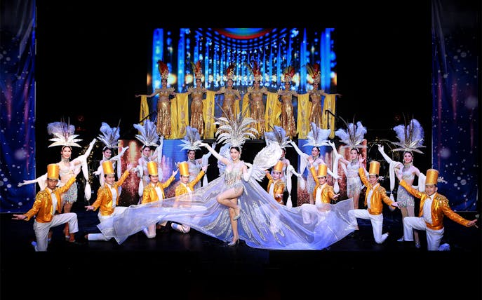 Performers in elaborate costumes on stage at Siam Dragon Cabaret Show, Thailand.