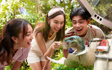 Visitors interacting with a dinosaur hatchling at Jurassic Park Adventure, Universal Studios Singapore.