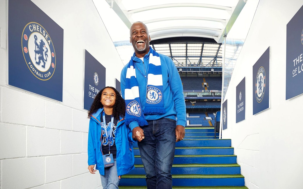 Father and daughter at Chelsea FC stadium entrance, London Explorer Pass.