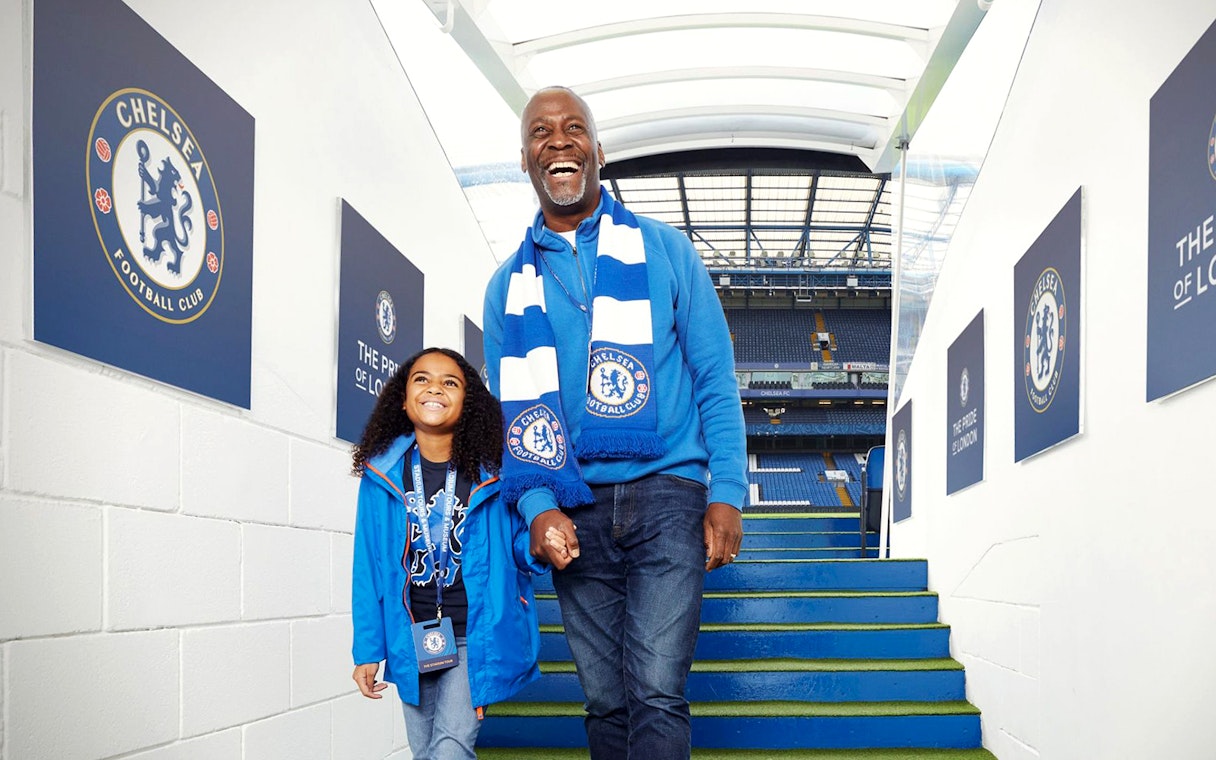 Father and daughter at Chelsea FC stadium entrance, London Explorer Pass.