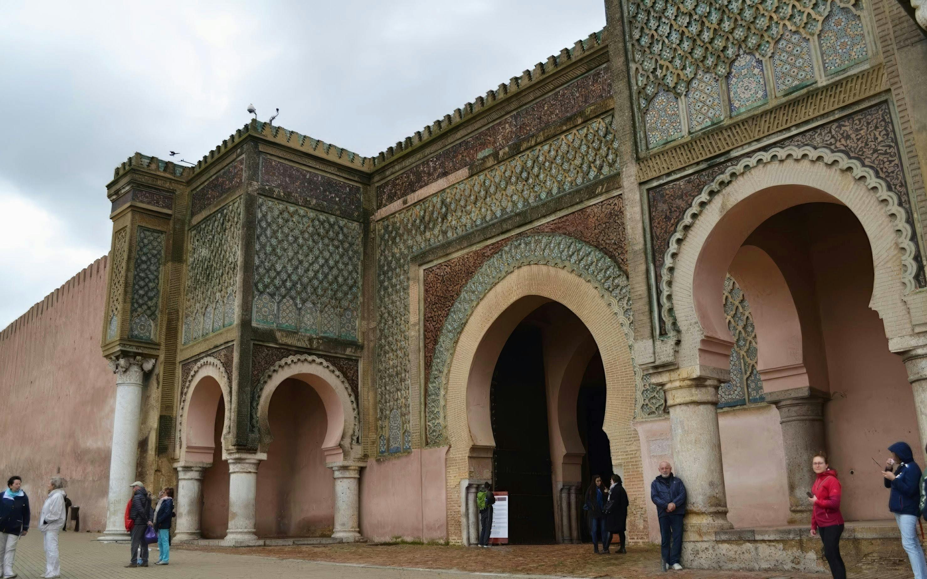 Bab Mansour Gate in Meknes with intricate tilework and arches.