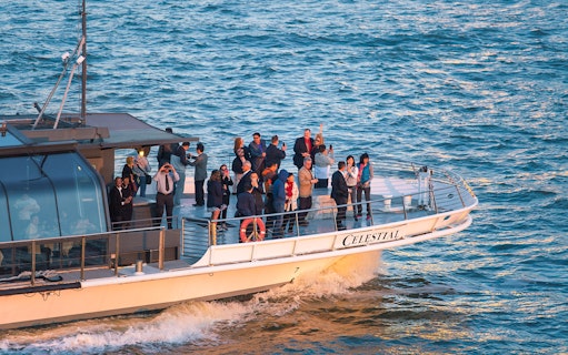 Guests enjoying views on Bateaux New York Premier Dinner Cruise.