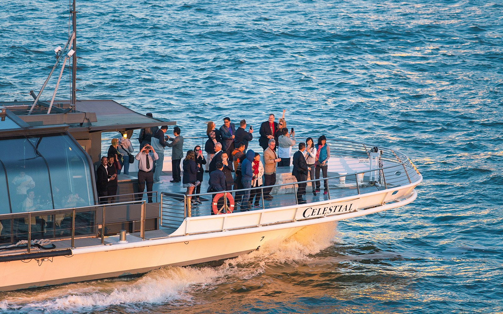 Bateaux New York Premier Dinner Cruise with skyline view of Manhattan at sunset.