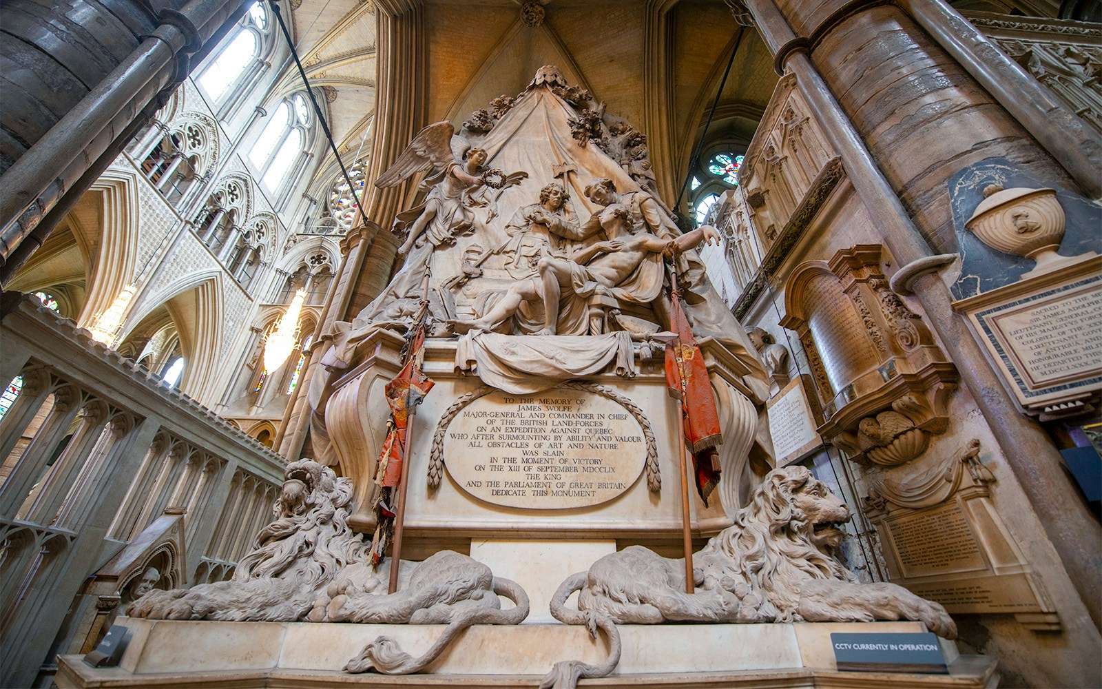 Monument inside Westminster Abbey with intricate sculptures and historical inscriptions.
