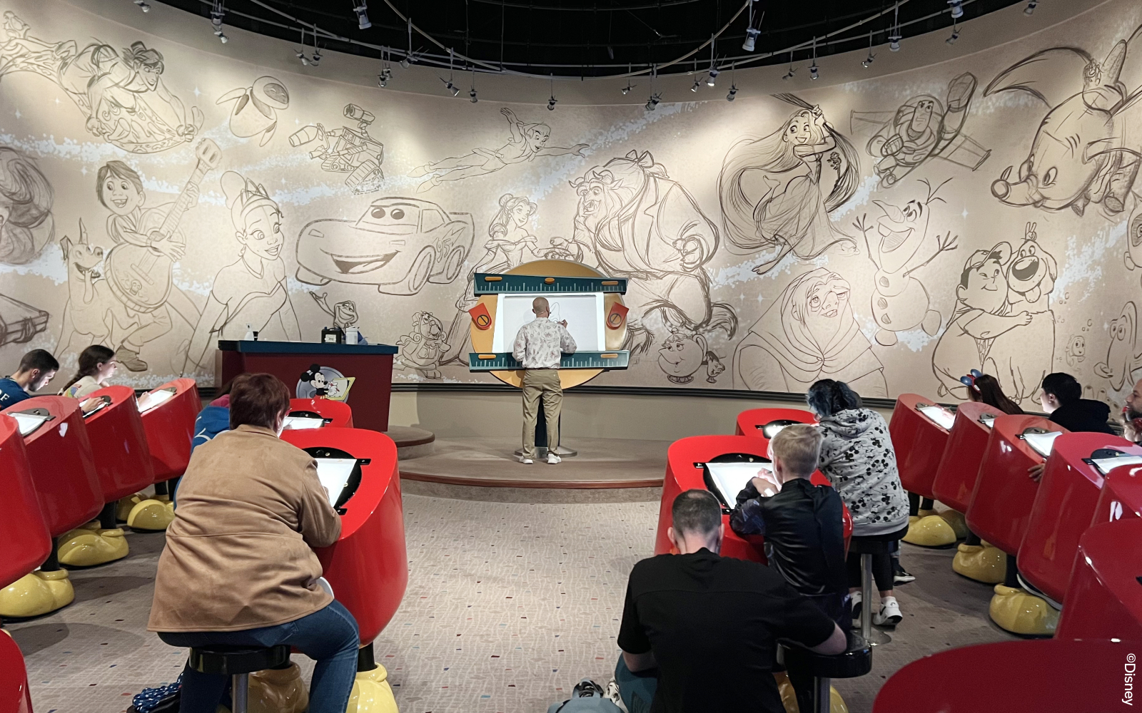 Disneyland Paris Animation Academy guests drawing characters.