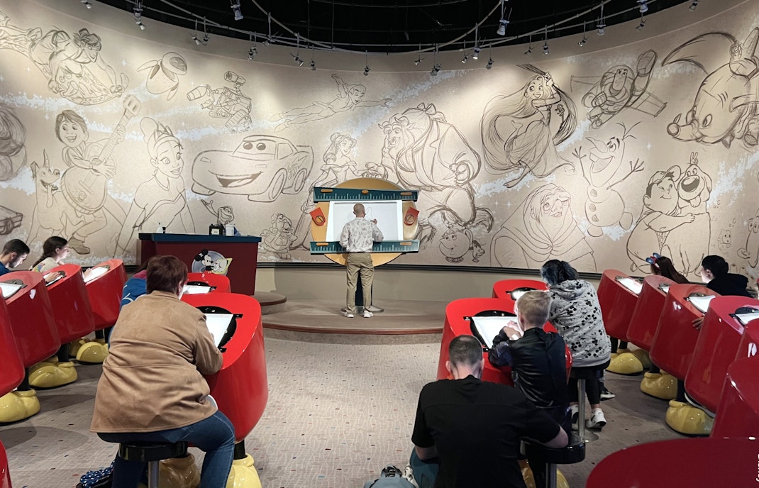 Disneyland Paris Animation Academy guests drawing characters.