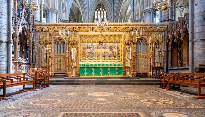 High Altar at Westminster Abbey with ornate gold detailing and religious artwork.