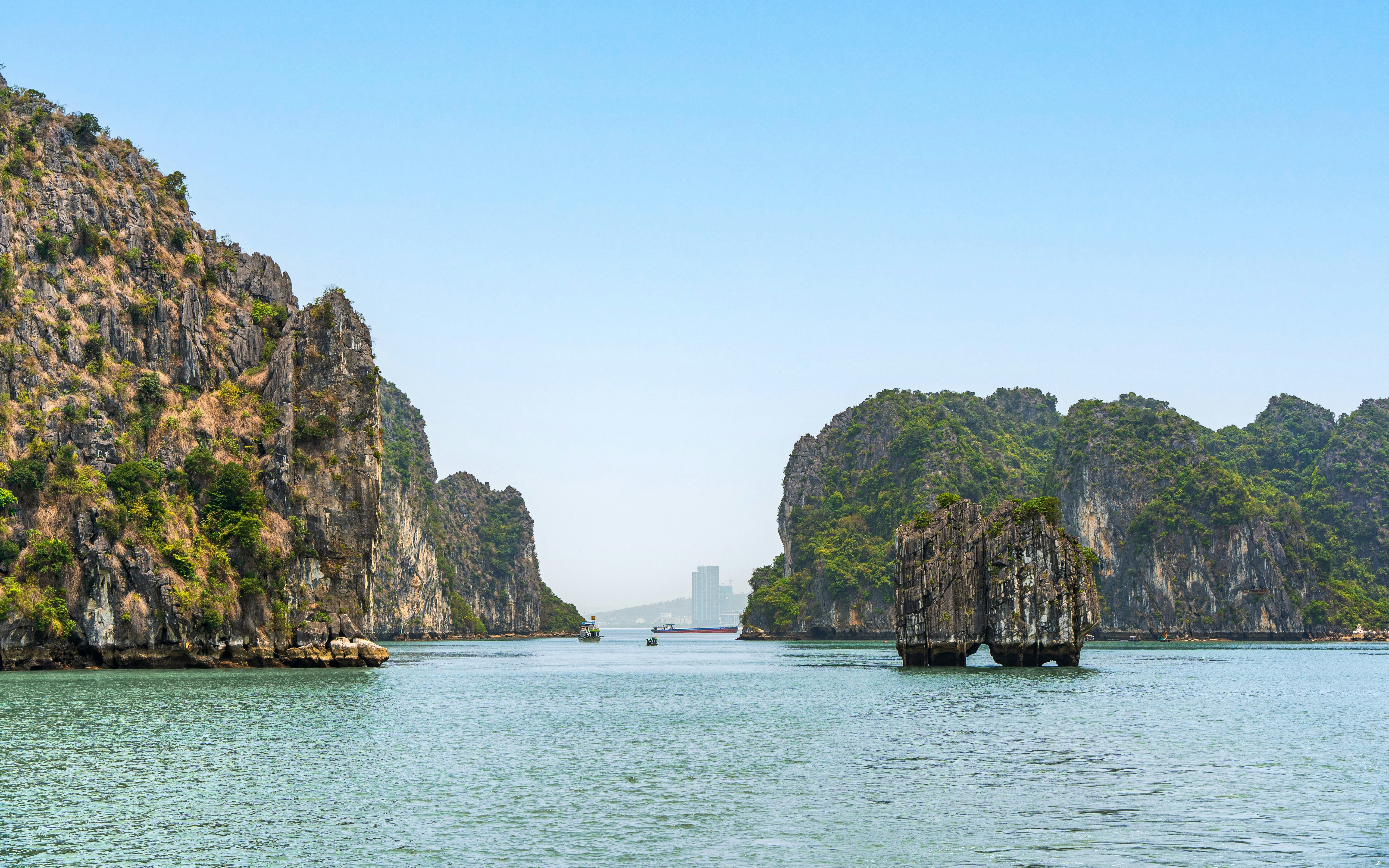 Dinh Huong Islet in Ha Long Bay, surrounded by limestone cliffs and calm waters, Quang Ninh, Vietnam.