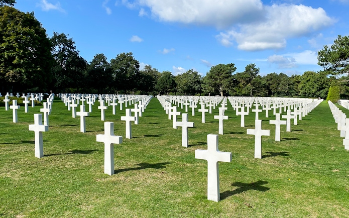 Rows of white crosses at Normandy American Cemetery, France, on a D-Day Normandy Beaches day trip from Paris.