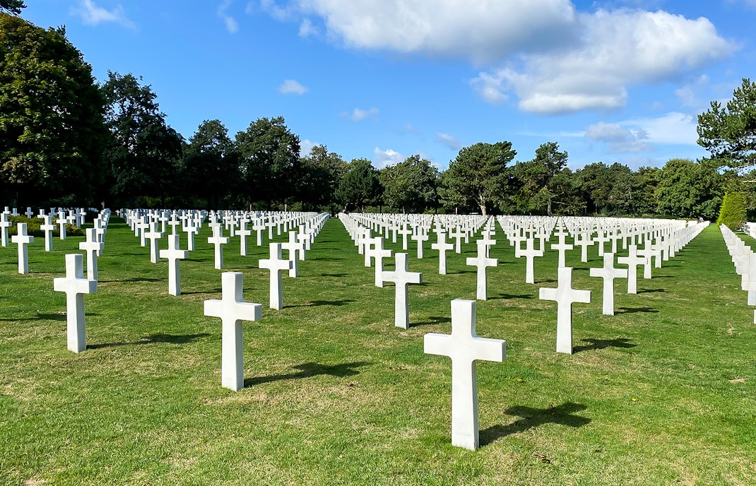 Rows of white crosses at Normandy American Cemetery, France, on a D-Day Normandy Beaches day trip from Paris.