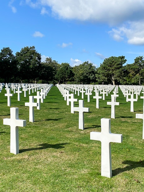 Rows of white crosses at Normandy American Cemetery, France, on a D-Day Normandy Beaches day trip from Paris.