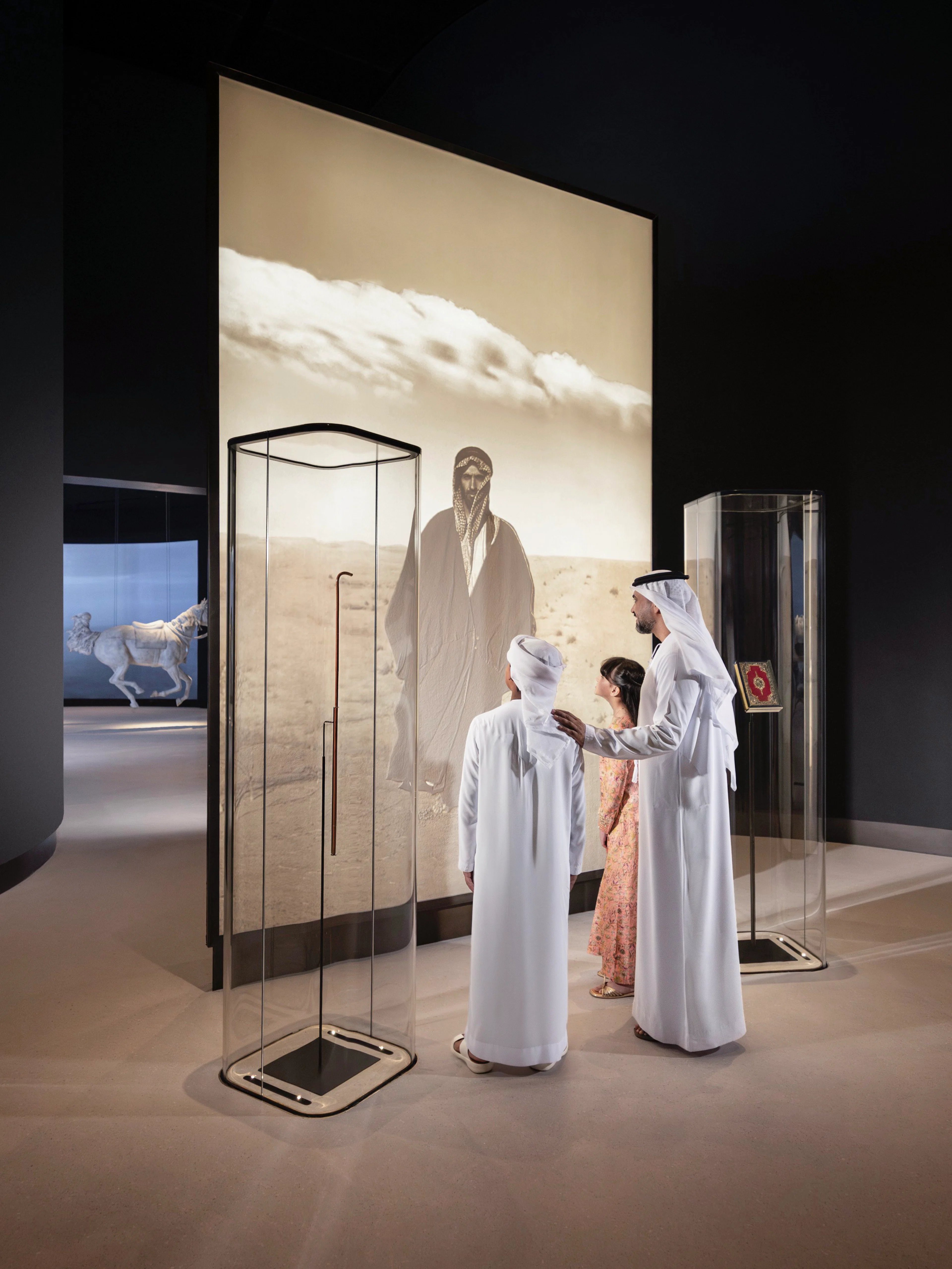 Visitors viewing exhibit at Zayed National Museum, Abu Dhabi.