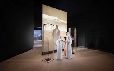 Visitors viewing exhibit at Zayed National Museum, Abu Dhabi.