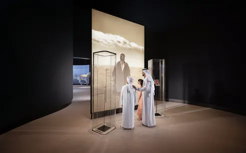 Visitors viewing exhibit at Zayed National Museum, Abu Dhabi.