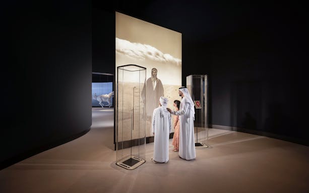 Visitors viewing exhibit at Zayed National Museum, Abu Dhabi.