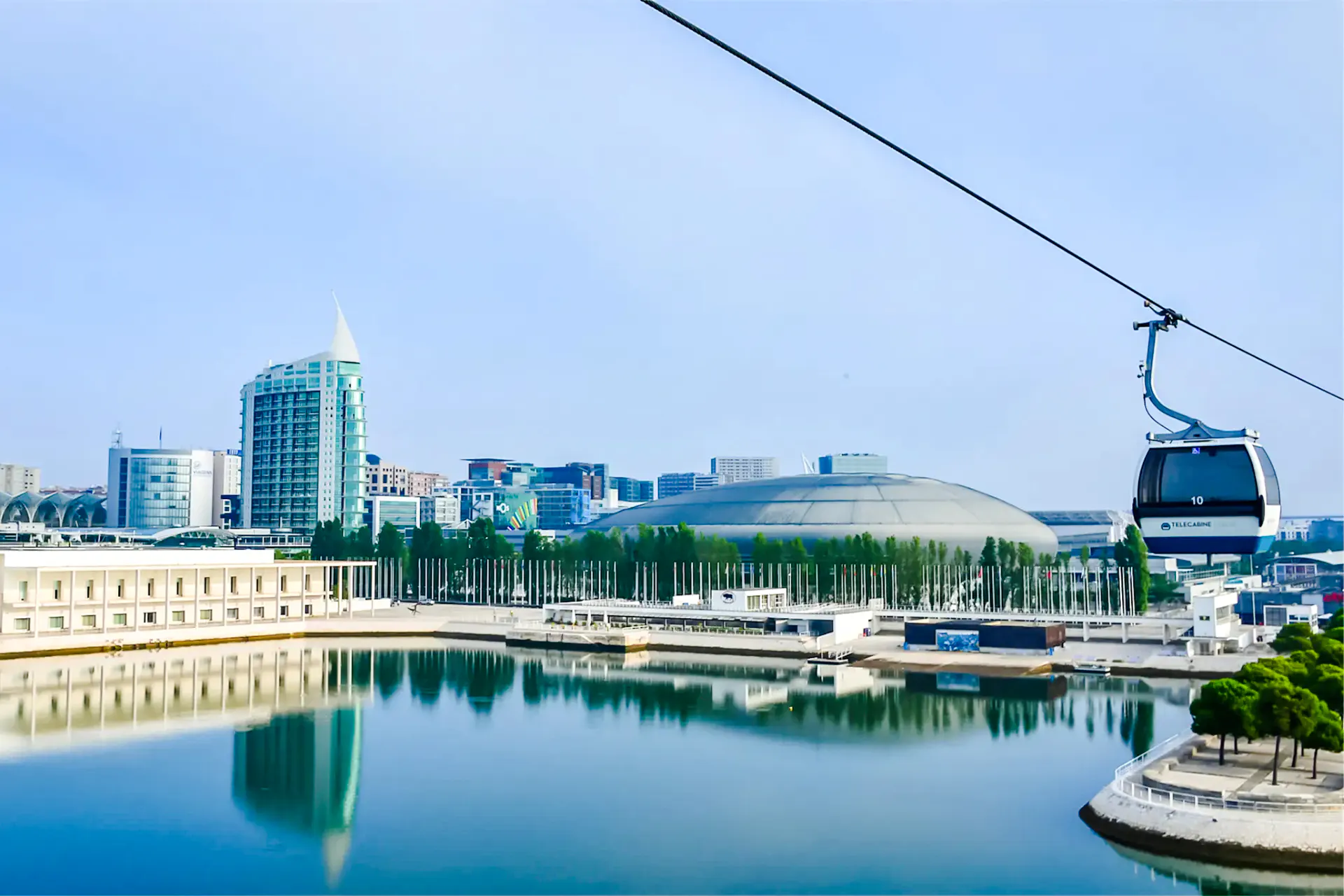 Lisbon cable car over Tagus River with cityscape in background.