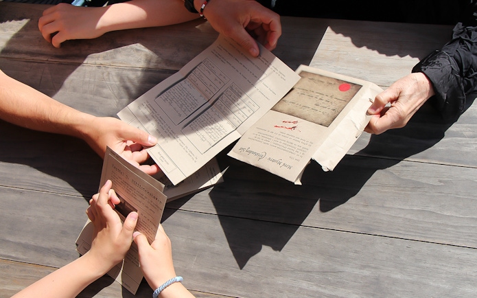 Participants examining mystery documents during Nyhavn adventure in Copenhagen.