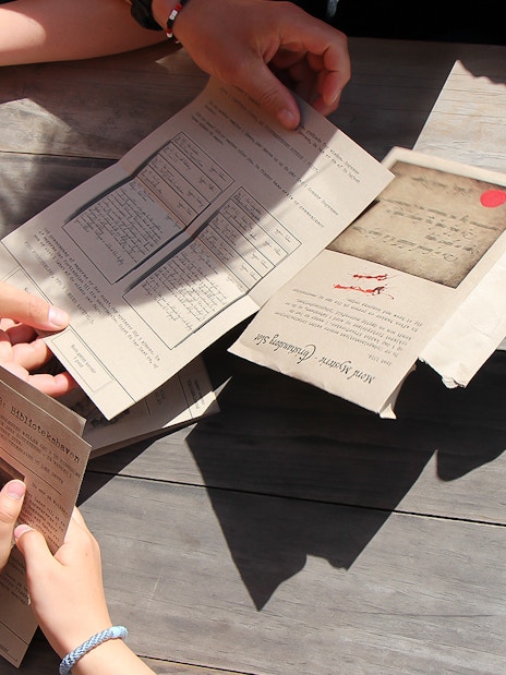 Participants examining mystery documents during Nyhavn adventure in Copenhagen.