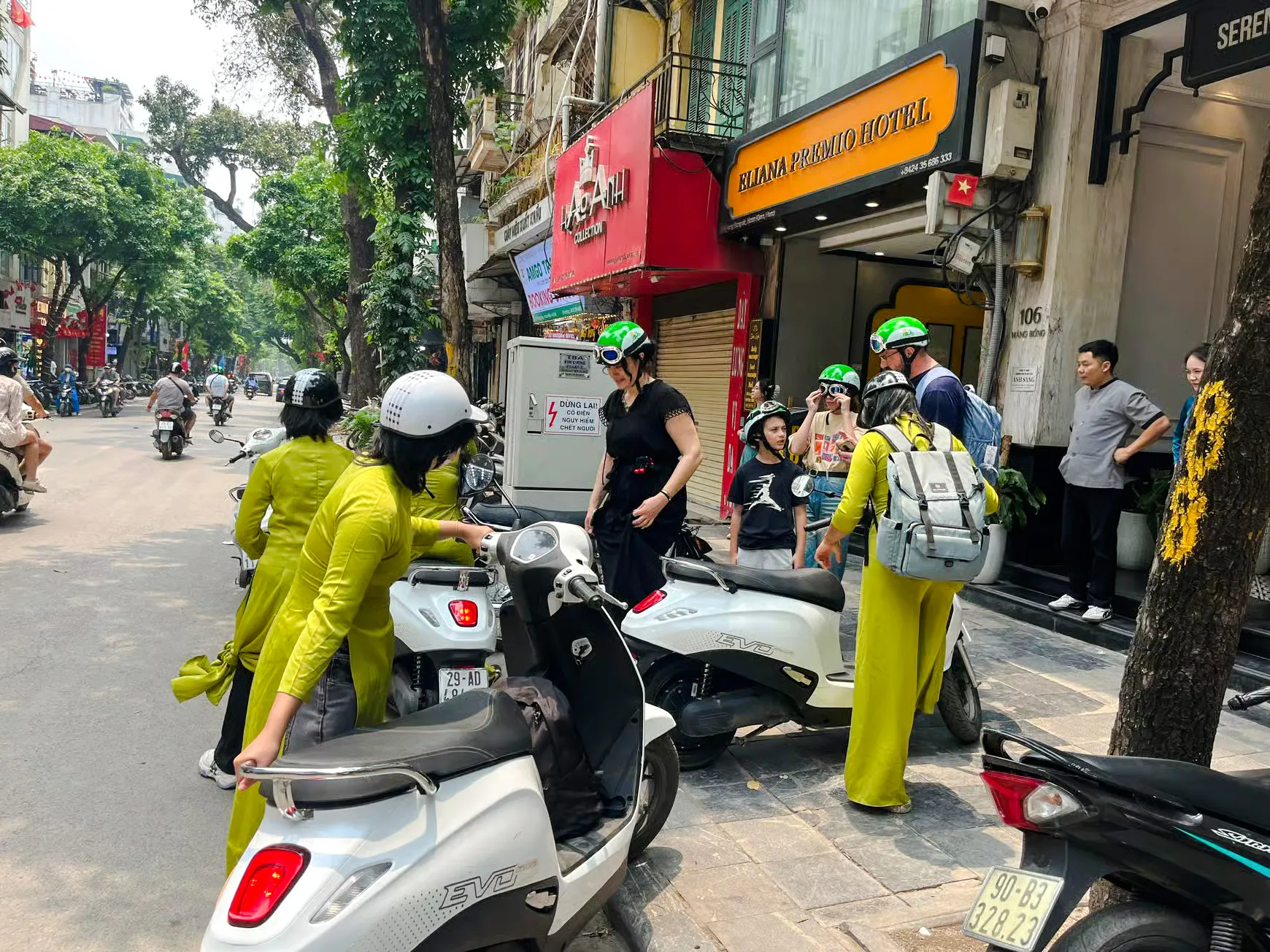 Female riders preparing for Hanoi motorbike tour near Train Street.