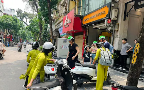 Female riders preparing for Hanoi motorbike tour near Train Street.