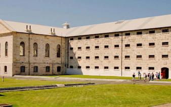 Tourists gather at the entrance of Fremantle Prison in Australia.