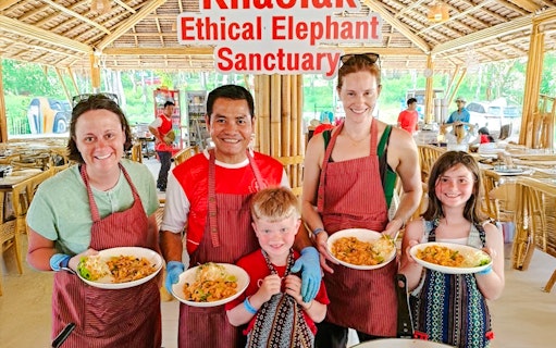 Cooking class participants holding dishes at Khao Lak Elephant Sanctuary.