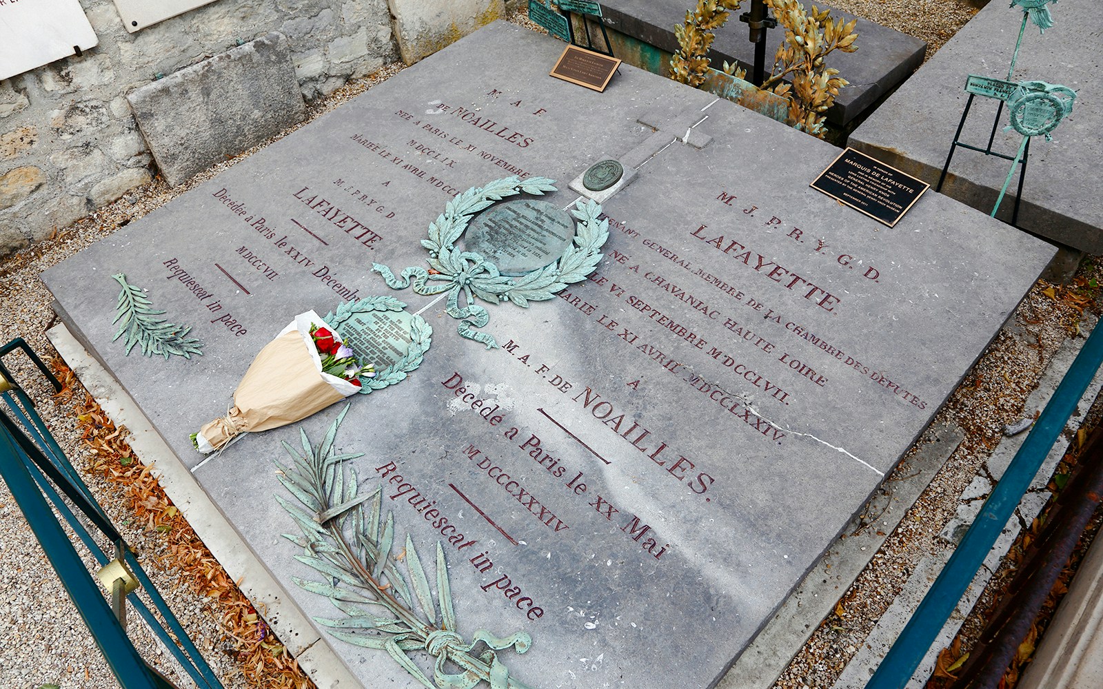 Gravestone of Lafayette in Lafayette Cemetery, New Orleans, with engraved text and floral tribute.